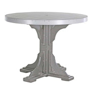 A round outdoor dining table with a distressed silver-gray finish, featuring a slatted top and a decorative pedestal base with rivet details.