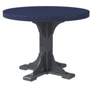 A round outdoor dining table with a dark navy blue slatted top and a dark gray trestle-style pedestal base, shown on a plain white background.