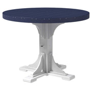 A round outdoor dining table with a dark navy blue slatted top and a white pedestal base, shown on a plain white background.