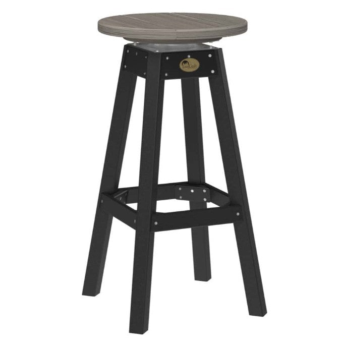 A swivel bar stool with a round gray seat and a black four-legged frame, featuring a small oval metal emblem on the upper crossbar.