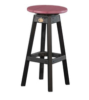 A rustic counter stool with a round dusty red seat and a dark, weathered black frame with a footrest.