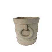 Decorative stone pot with circular design on a white background