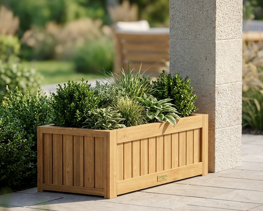 Teak straight wooden planter with lush greens and plants on a stone patio next to a stone column. 