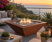 HPC Sedona 40-inch Hammered Copper Fire Bowl on a stone patio with ocean views.  