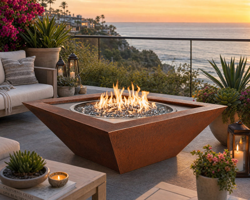 HPC Sedona 40-inch Hammered Copper Fire Bowl on a stone patio with ocean views.  