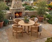 Anderson Teak Tosca 5-piece dining set on a stone patio with fireplace and canyon views.  