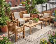 Anderson Teak classic 3-seater 4 piece conversation set on a wooden patio in the city surrounded by plants.  