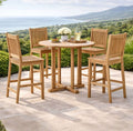 Anderson Teak Bahama Avalon 5-Piece Round Bar Set on a stone patio with ocean views.  