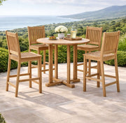 Anderson Teak Bahama Avalon 5-Piece Round Bar Set on a stone patio with ocean views.  