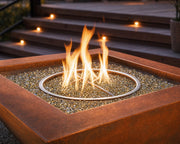 Close up image of the Sierra 36-inch smooth copper fire bowl that empahsizes the copper, glass fire media and flame.  