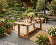 Anderson Teak Smyrna dining table on a stone patio in an elegant backyard environment.  