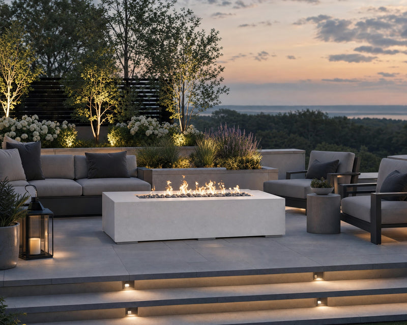 Sonoma 56-inch natural concrete fire pit on a stone patio seating area with views of a lake in the distance.  