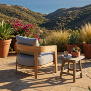 Back view of the toscana lounge chair on a stone patio overlooking canyon views and the ocean.  