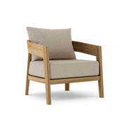 Toscana teak lounge chair with cast ash cushion on white background. 