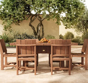 outdoor dining set with fruit basket under a tree