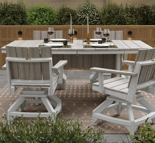 Outdoor dining set featuring an oval white slat-top table surrounded by four matching high-back chairs with gray slatted backs, set on a patterned patio rug with a wooden fence and greenery in the background.