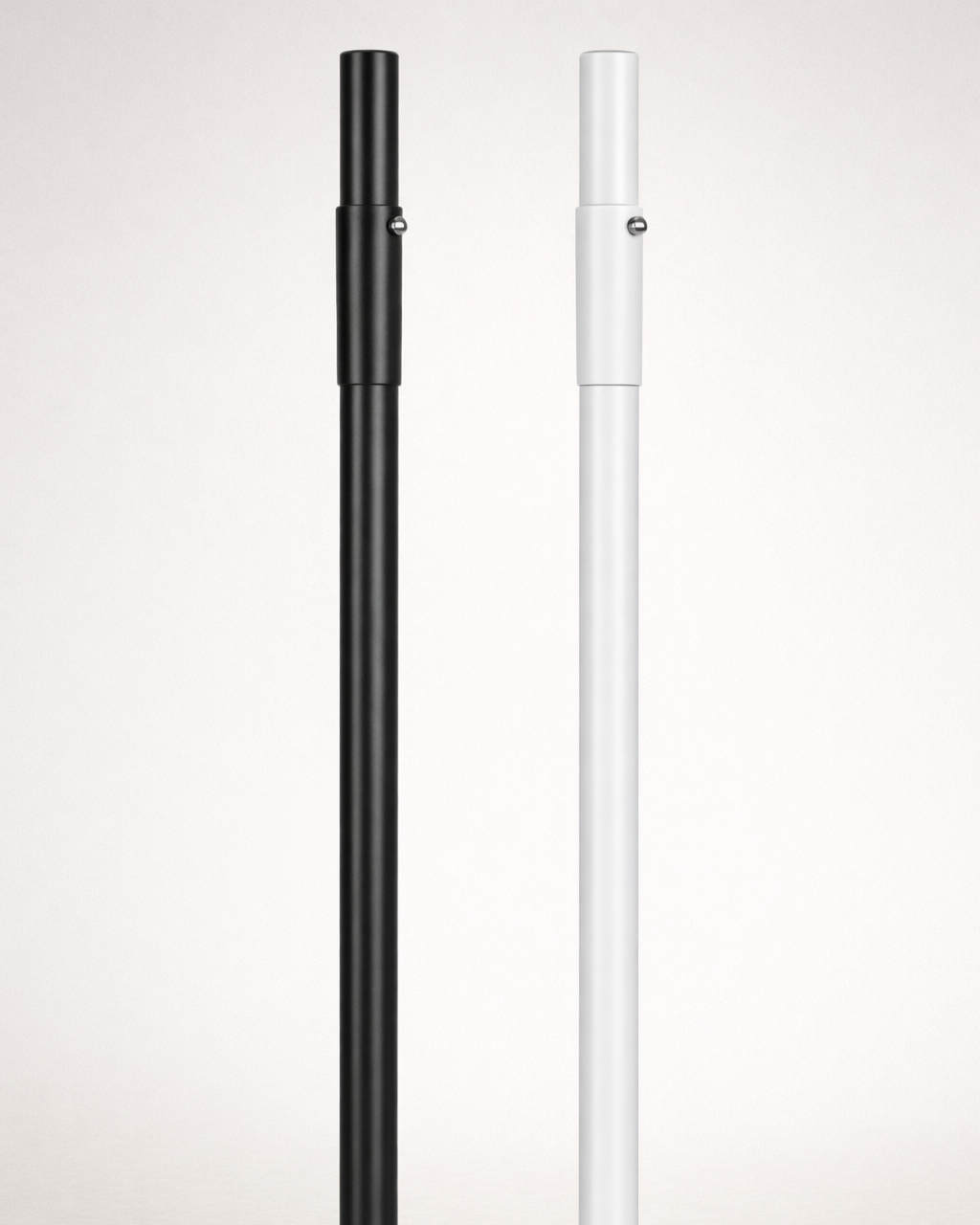 Black and white umbrella poles on a light gray background