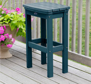 Blue outdoor stool on a wooden deck with pink flowers in the background