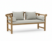 A wooden outdoor bench with a light beige textured fabric seat and back cushions, featuring two square pillows and two cylindrical bolster pillows, shown on a white background.