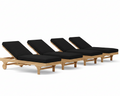 Four wooden lounge chairs with black cushions on a white background