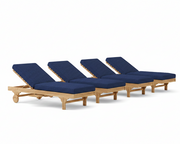 Four wooden lounge chairs with navy cushions on a white background