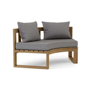 Circular teak bench with cast slate cushions on a white background.  