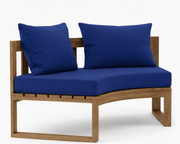 Circular teak bench with true blue cushions on a white background.  