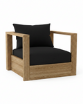 A modern outdoor armchair with a natural oak wood frame and thick black cushions, shown on a solid white background.