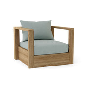 Wooden armchair with light blue cushions on a white background