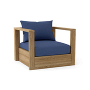 Wooden armchair with blue cushions on a white background