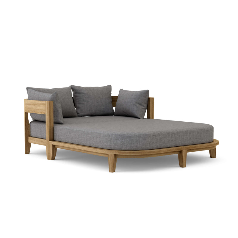 Coronado teak day bed with cast slate cushion on white background.