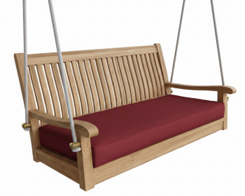 Wooden porch swing with red cushion on a white background