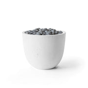 Element natural lightweight concrete firepit with slate beach stones on a white background.  