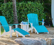 LuxCraft End table in white shown with two Adirondack chairs on a sandy beach.  