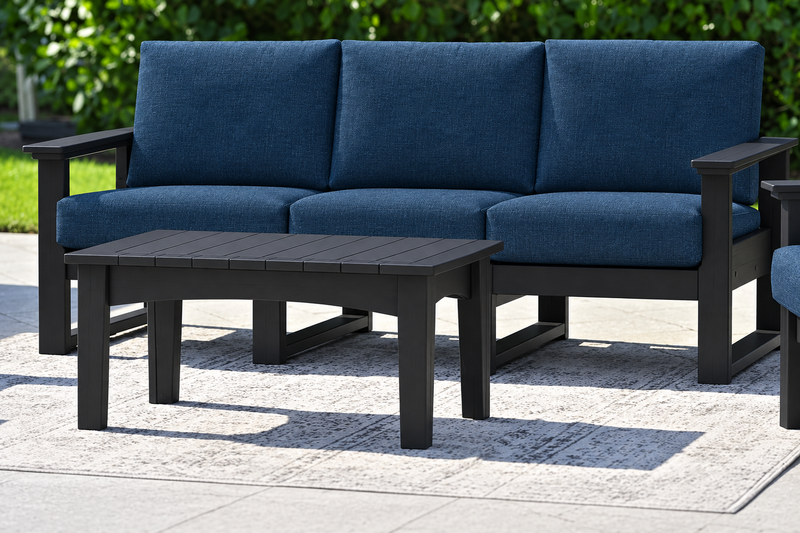 LuxCraft Lanai deep seating sofa with black frame, bare black coffee table and Spectrum Indigo cushions