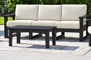 LuxCraft Lanai deep seating sofa with black frame, bare black coffee table and Canvas cushions
