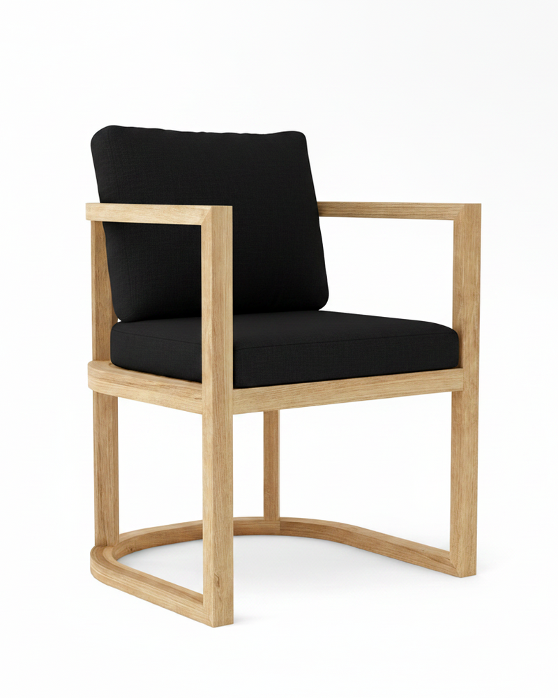 Anderson teak junus dining armchair with black cushions on white background.  