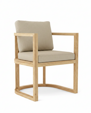 Anderson teak junus dining armchair with cast ash cushions on white background.  