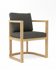Anderson teak junus dining armchair with cast charcoal cushions on white background.  