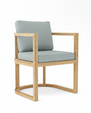Anderson teak junus dining armchair with cast mist cushions on white background.  