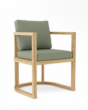 Anderson teak junus dining armchair with cast sage cushions on white background.  