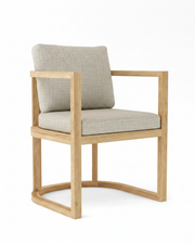 Anderson teak junus dining armchair with cast silver cushions on white background.  