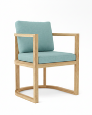 Anderson teak junus dining armchair with mineral blue cushions on white background.  