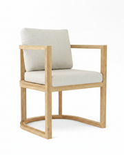 Anderson teak junus dining armchair with natural cushions on white background.  
