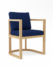 Anderson teak junus dining armchair with navy cushions on white background.  