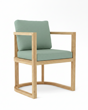 Anderson teak junus dining armchair with spa colored cushions on white background.  