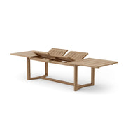 Junus teak extension dining table with pop up leaves on a white background.  