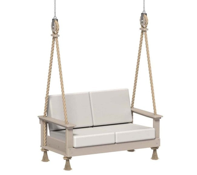 Beige swing with white cushions hanging on a white background