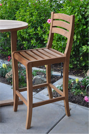 Wooden bar stool on a patio with a garden background