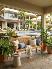 Anderson Teak Sahara 3-seater bench on stone patio under a covered lanai.
